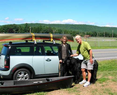 A couple and a big dog ready for canoeing